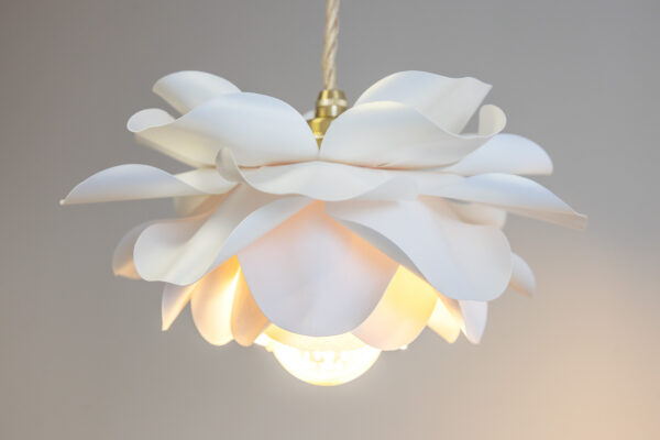 Close-up of white flower petal pendant light, handmade floral ceiling lamp