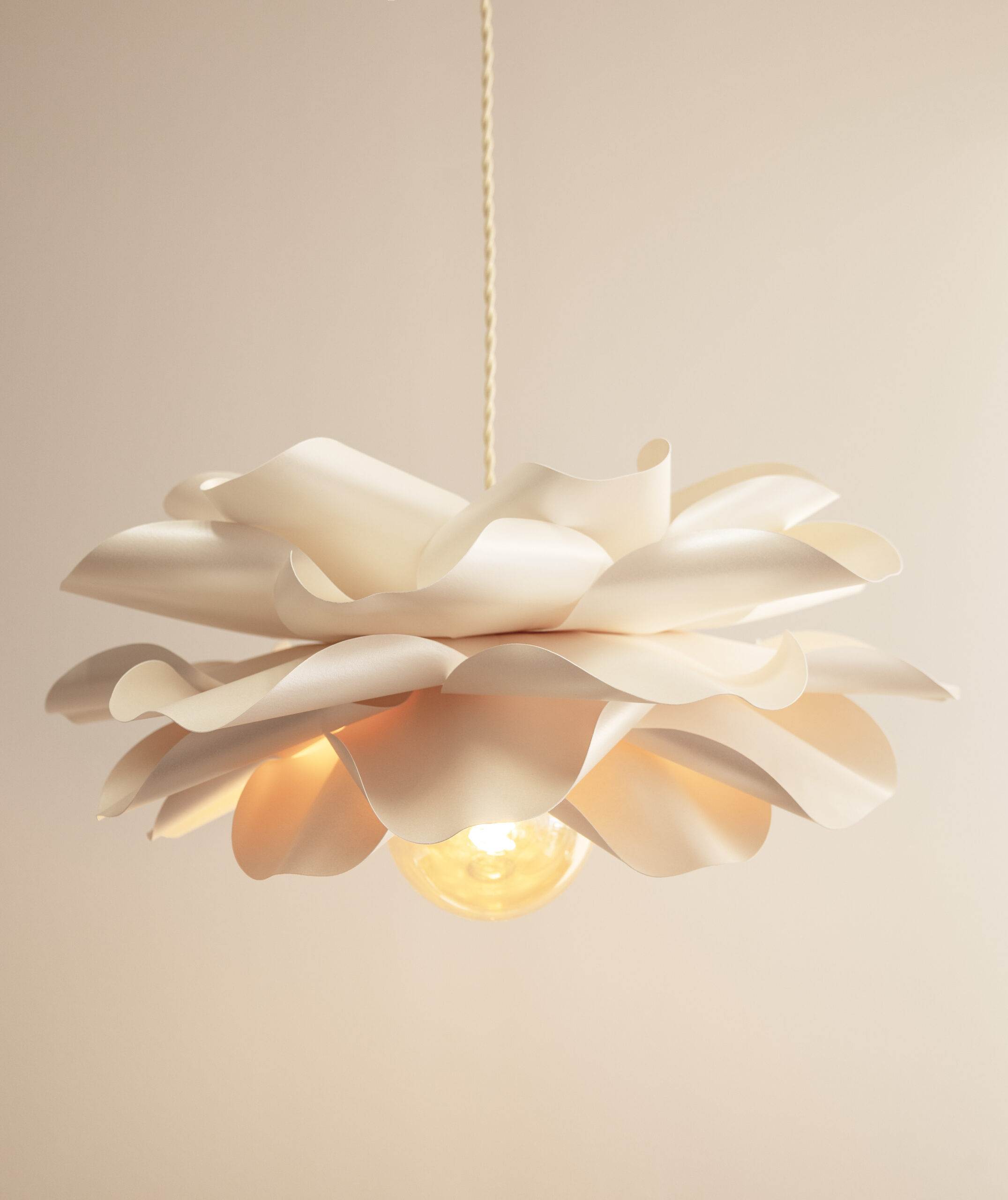 Modern handmade floral pendant light with sculptural paper petals and warm ambient glow