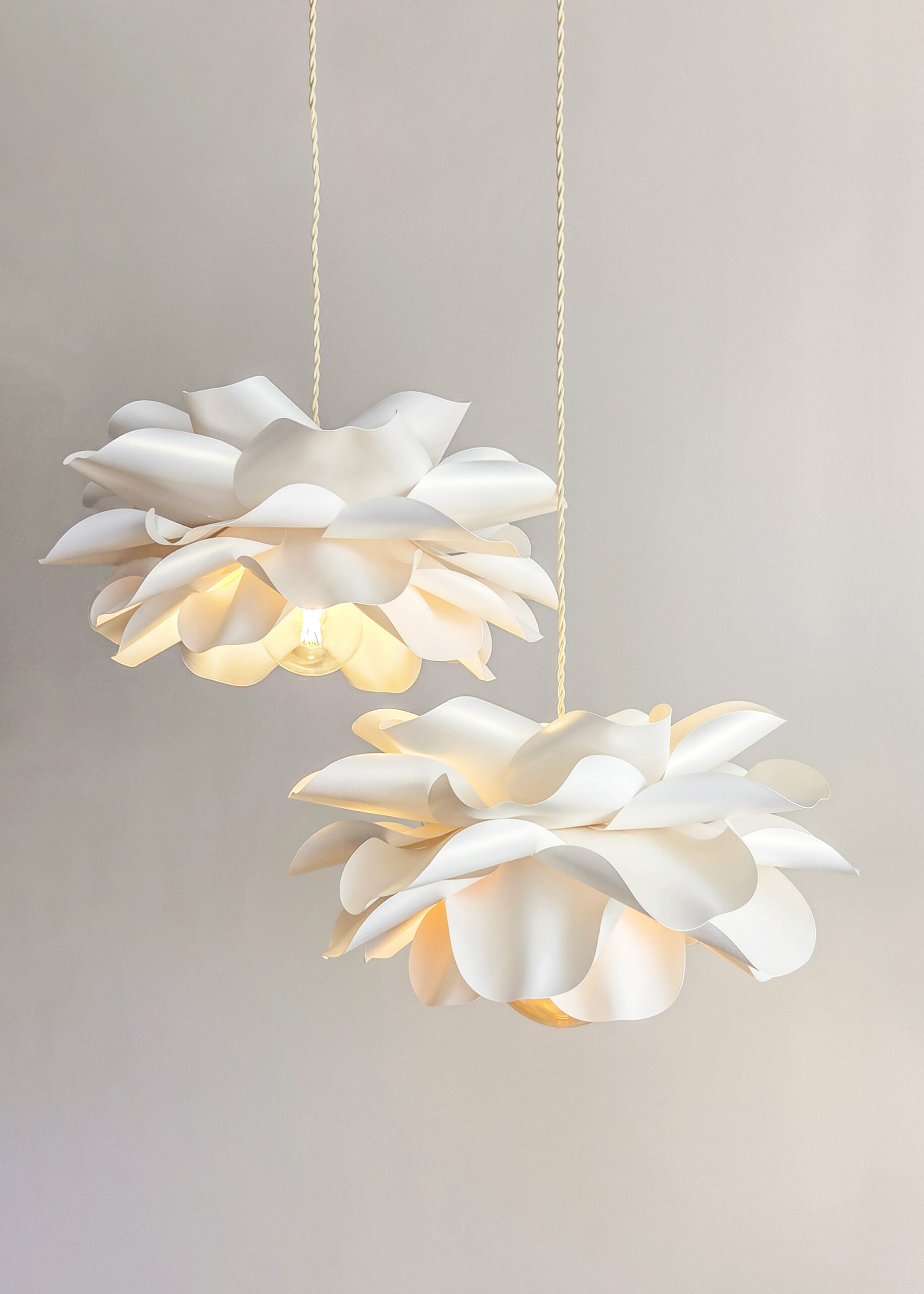 Close-up of ivory flower ceiling lights with layered sculptural petals